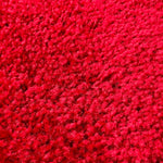 A close-up texture shot of a bright red carpet rental.