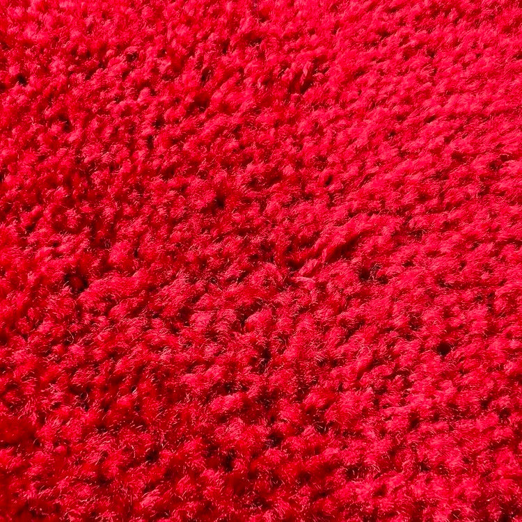 A close-up texture shot of a bright red carpet rental.