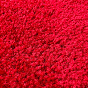 A close-up texture shot of a bright red carpet rental.